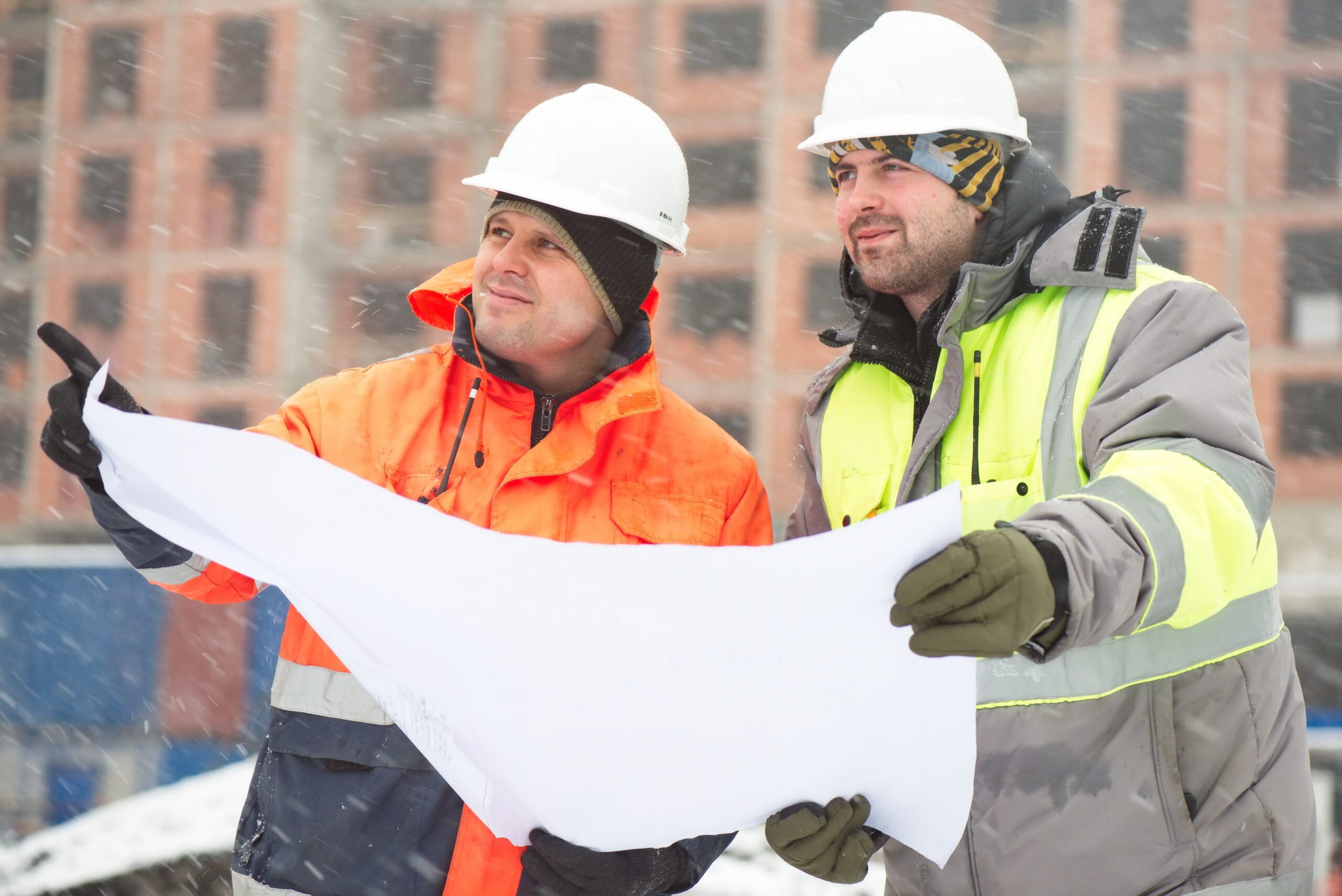 Workers looking at the design layout
